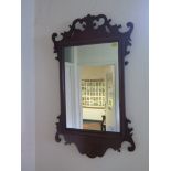 A George II style mahogany fret carved wall mirror, with rectangular plate 67cm x 40cm