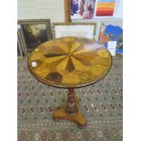 An early Victorian occasional table, the circular top inlaid with various timber specimens on a