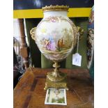 A French porcelain vase, with gilt metal ram head mounts and socle base depicting gardening and a