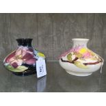Two Moorcroft pottery Magnolia pattern squat vases, in cream and pink, and green and purple 10.5cm