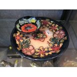 A Moorcroft Pottery Oberon pattern charger 26cm diameter and a poppy design dish 12cm diameter (2)