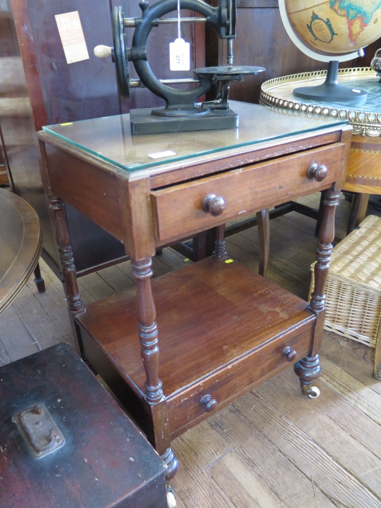 A Victorian mahogany two tier whatnot, each tier with a drawer on turned supports and pot castors