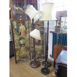 A 1940s chrome and black metal standard lamp and two turned wood standard lamps (3)