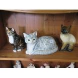 A Babbacombe Devon pottery figure of a seated cat, 21cm high and two other cat figures