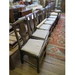 A set of six George III and later elm dining chairs, the shaped top rails over solid vase shape