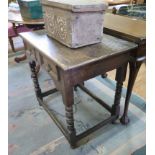 An 18th century oak side table, with panelled frieze drawer on bobbin turned legs joined by