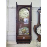 An Edwardian mahogany wall clock, inscribed Seth Thomas, the twin train movement striking a bell