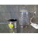 A highly decorated Victorian silver mustard and another with spoon