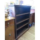 A walnut open bookcase, the adjustable shelves on fluted supports and plinth base 86cm wide 28cm