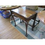 A mahogany foldover card table, the gadrooned edge on cabochon carved cabriole legs on ball and claw