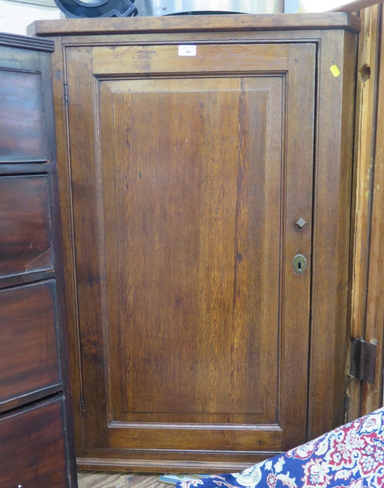 A 19th century oak corner cupboard, with panelled door, 77cm x 109cm