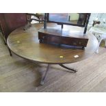 A crossbanded mahogany coffee table in George III style, on a quadruped base with lion paw feet