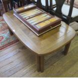 A 1970s oak coffee table with panelled top and chamfered legs, 111cm wide