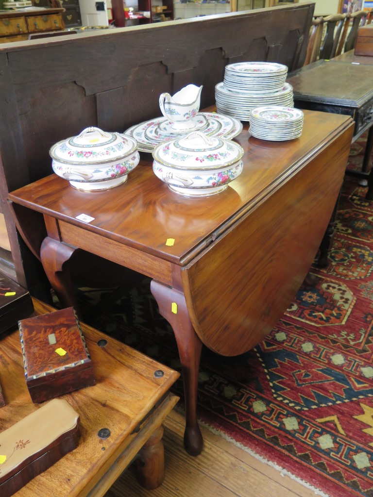 A mahogany George III style drop leaf table, the oval top on cabriole legs and club feet, 104cm
