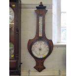 An Edwardian inlaid rosewood banjo barometer, of shield shape with thermometer and ceramic dial 85cm