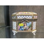 A Continental porcelain casket, printed with panels of courting couples within diaper borders,