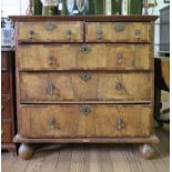 A Queen Anne crossbanded walnut chest of drawers, with two short and three long graduated drawers on
