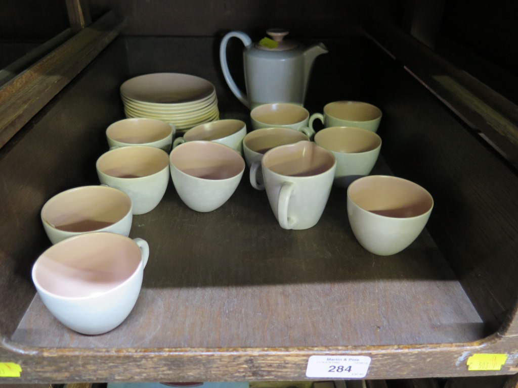 A Poole Pottery pink and beige coffee service, with ten coffee cups and saucers, coffee pot, cream