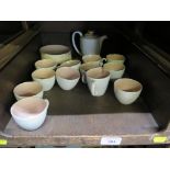 A Poole Pottery pink and beige coffee service, with ten coffee cups and saucers, coffee pot, cream