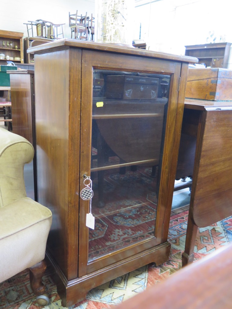 A stained beech display cabinet, with single glazed door on bracket feet and castors, 53cm wide 93cm