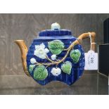 A Joseph Roth Majolica teapot, with relief decoration of rosehip flowers and branch form spout and