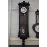 An ebonised and rosewood Vienna wall clock, with enamelled dial, the case with applied
