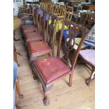 A set of four George III style mahogany dining chairs, the carved top rails over pierced C-scroll