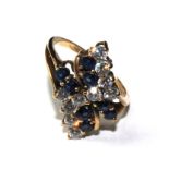 A 9 carat gold ring set with blue and white stones