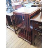 A reproduction inlaid mahogany revolving bookcase, with patera top and ogee bracket feet, 81cm high,