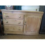 A Victorian pine dresser, with cupboard door beside three graduated drawers on ball feet, 121cm