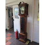 A mahogany longcase clock by Emperor, the broken arch over a brass dial and glazed trunk door, the