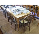 A pine kitchen table with turned legs 75cm wide, 122cm long, and five Windsor chairs