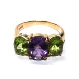 A 14 carat gold ring set with amethyst and peridot