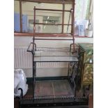 A wrought iron two tier trolley with glass shelves, 85cm high, an iron fire fender, and a mahogany