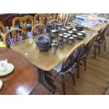 An oak dining table, with rectangular top and trestle base, and five Windsor chairs (6)