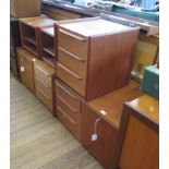 A pair of 1970s teak bedside cabinets with fall fronts and three drawers each 83cm wide, a further