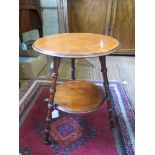 A circular occasional table on three turned legs with circular undershelf, 42cm diameter 56cm high