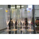 Four French glass champagne flutes with angel form stems 25cm high