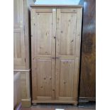 A pine twin door wardrobe 80cm wide, 52cm deep, 165cm high