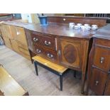 A bowfront mahogany sideboard with boxwood stringing and crossbanding, the two central drawers