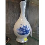 A Chinese blue and white baluster vase, the reeded body with three panels depicting landscapes,