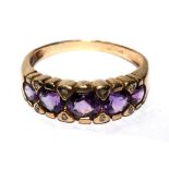 A five stone diamond and amethyst ring set in 9 carat gold