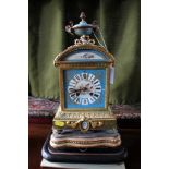 A French ormolu and porcelain mounted mantel clock, the blue ground panels depicting exotic birds,