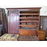 A Victorian mahogany triple door wardrobe, the mirror door flanked by panelled doors enclosing linen