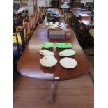 A reproduction crossbanded mahogany twin pedestal dining table, with one extra leaf, 228cm long,