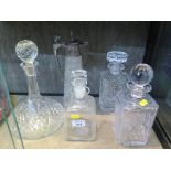 A cut glass ships decanter, 30cm high, a claret jug and three square decanters (5)