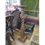 A mahogany jardiniere stand, the circular top on a double spiral and carved stem 118cm high