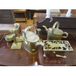 Two pairs of brass candlesticks, two brass watering cans. three dishes and a trivet