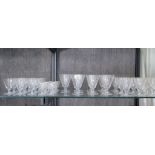 A 1930s set of conical form drinking glasses with etched decoration, including eleven water glasses,