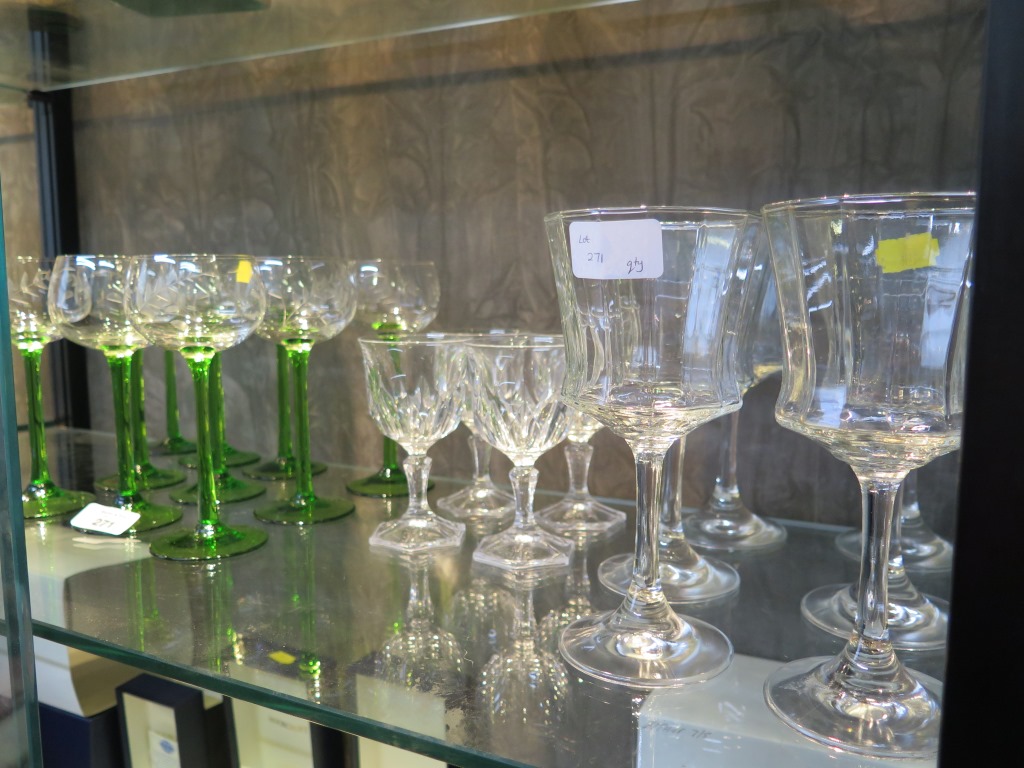 A set of ten green stemmed etched wine glasses, possibly German, and ten other wine glasses